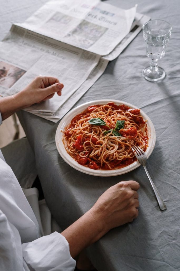 Enjoy a hearty plate of homemade spaghetti with basil. Classic dining experience.
